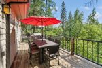 The back deck has a bbq and outdoor dining set.